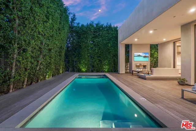 a dining room with wooden floor and large windows
