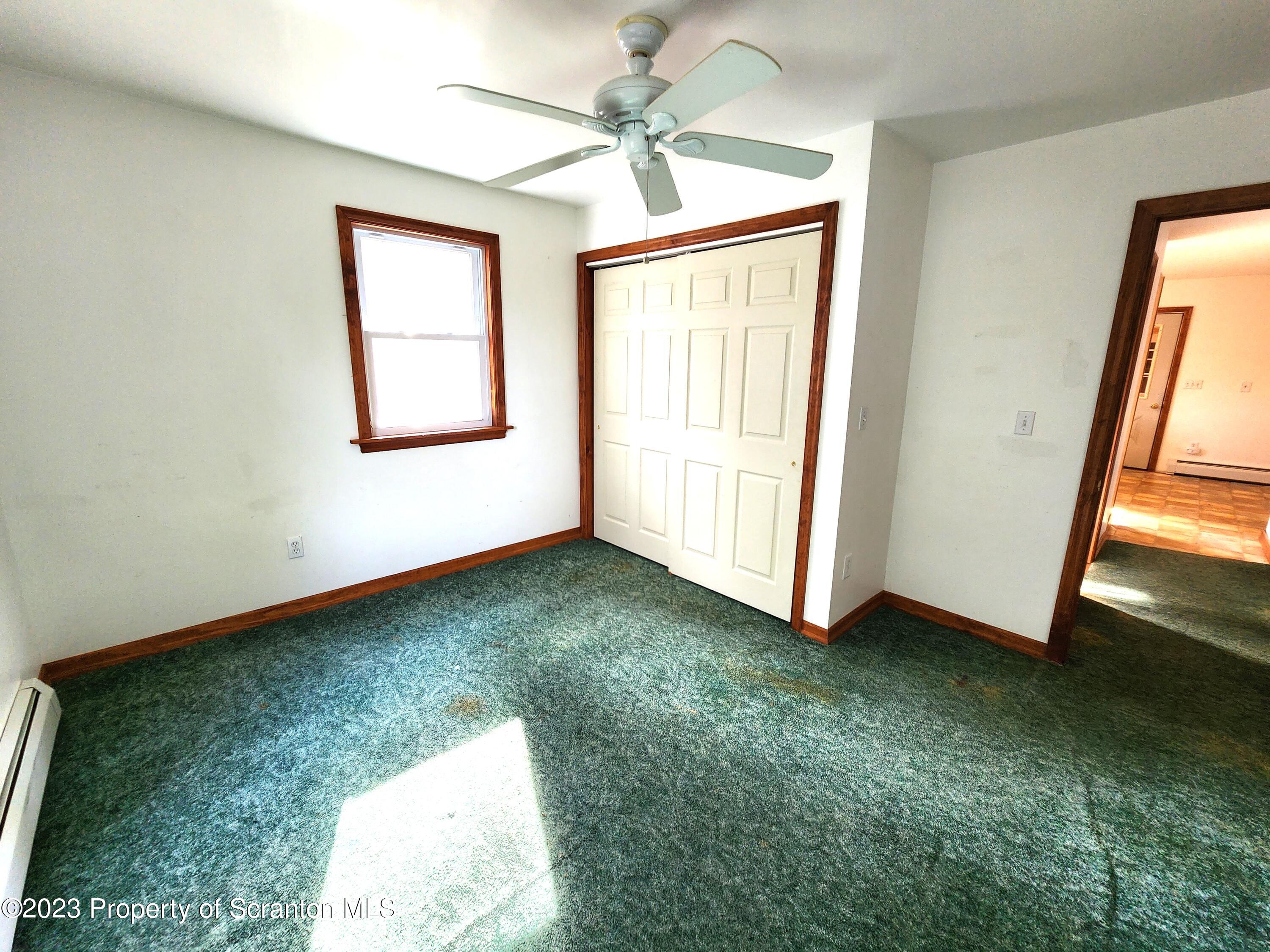 1575 State Rte 2009 Nicholson, PA 18446 - Photo 27 of 54 an empty room with a window and a ceiling fan
