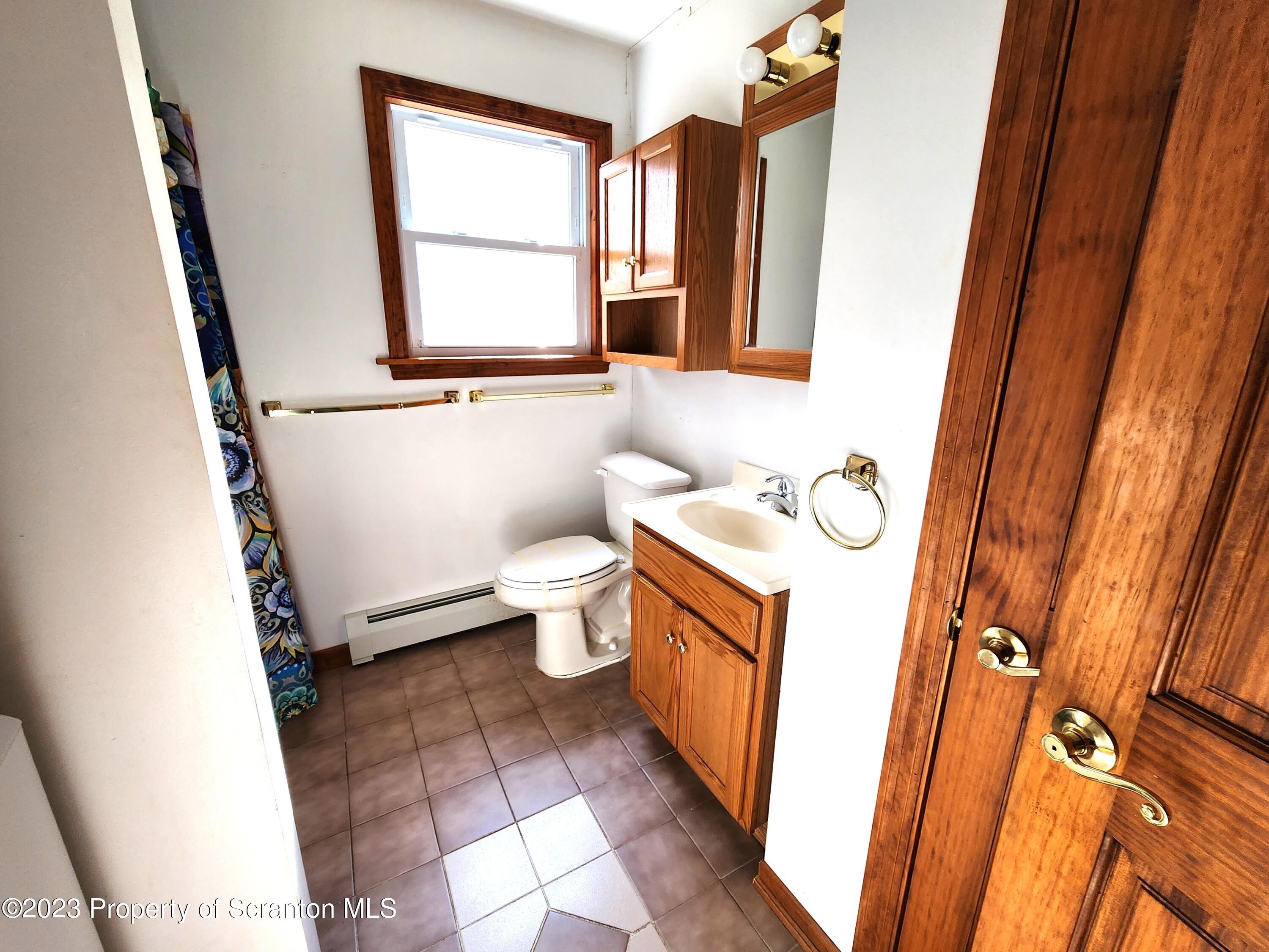 1575 State Rte 2009 Nicholson, PA 18446 - Photo 29 of 54 a bathroom with a sink toilet and mirror