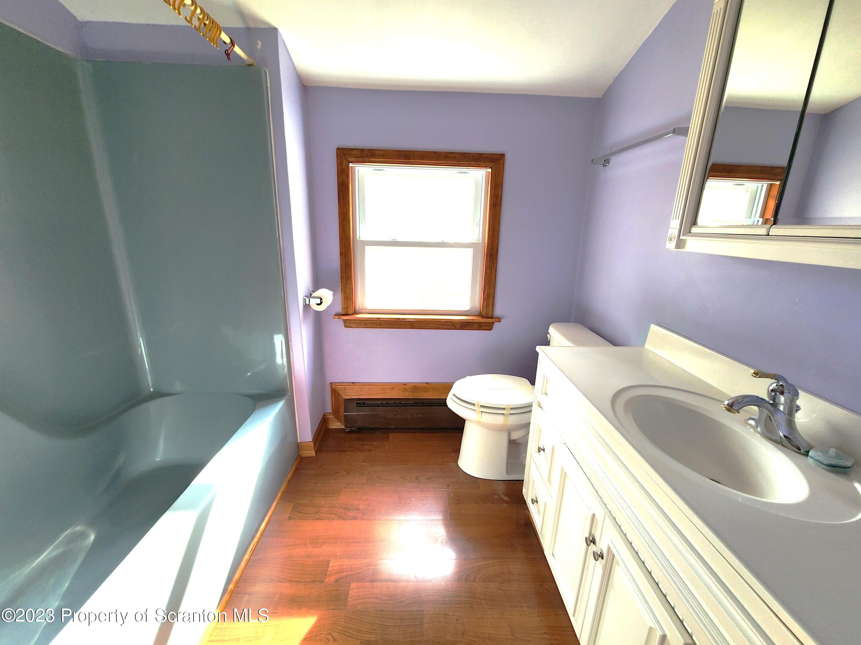 1575 State Rte 2009 Nicholson, PA 18446 - Photo 36 of 54 a spacious bathroom with a toilet sink and mirror