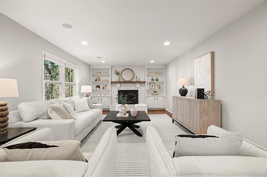 4367 Moss Ridge Court Northeast Roswell, GA 30075 - Photo 16 of 84 a living room with furniture and a fireplace