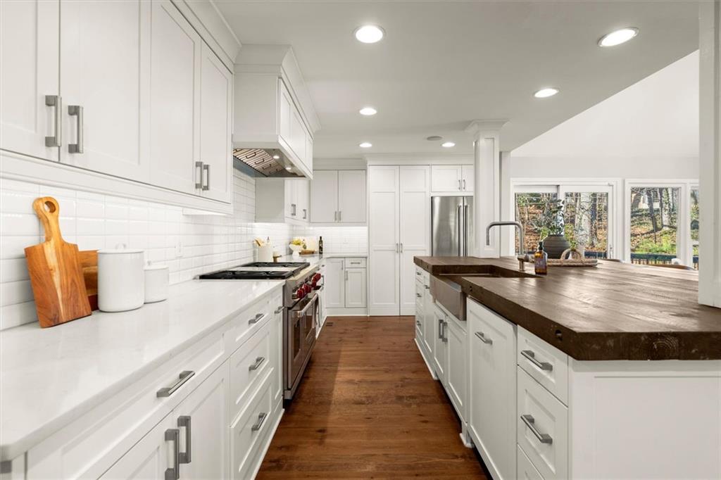 4367 Moss Ridge Court Northeast Roswell, GA 30075 - Photo 25 of 84 a kitchen with stainless steel appliances granite countertop a sink a stove and a wooden floors
