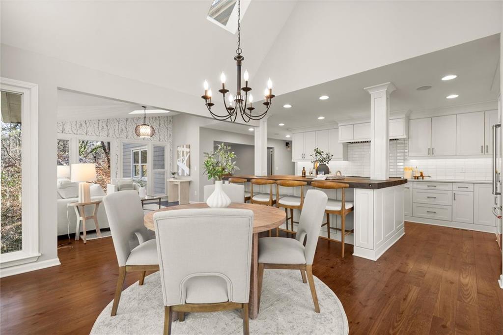 4367 Moss Ridge Court Northeast Roswell, GA 30075 - Photo 31 of 84 a living room with kitchen island furniture and a chandelier