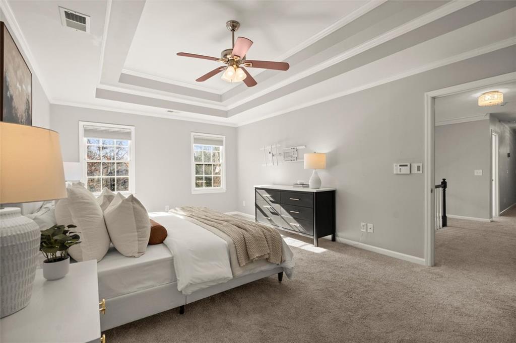 4367 Moss Ridge Court Northeast Roswell, GA 30075 - Photo 39 of 84 a spacious bedroom with a bed and a chandelier
