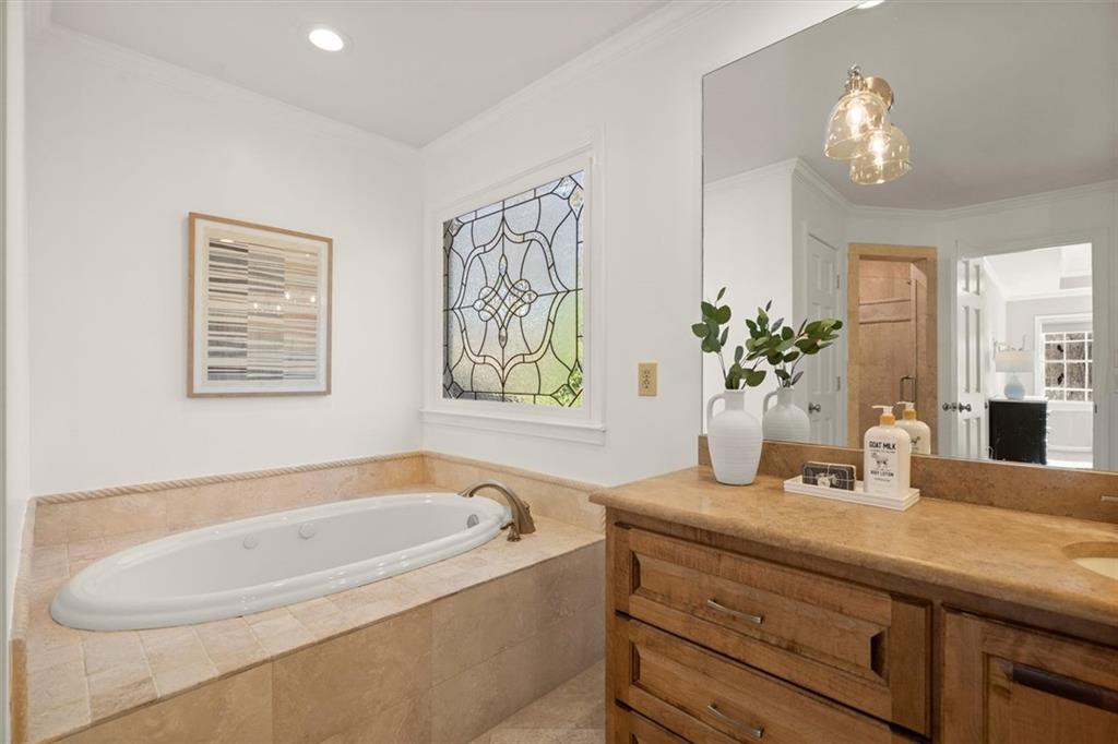 4367 Moss Ridge Court Northeast Roswell, GA 30075 - Photo 42 of 84 a bathroom with a tub sink and mirror