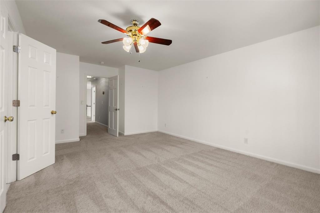4367 Moss Ridge Court Northeast Roswell, GA 30075 - Photo 53 of 84 an empty room with closet and a chandelier fan