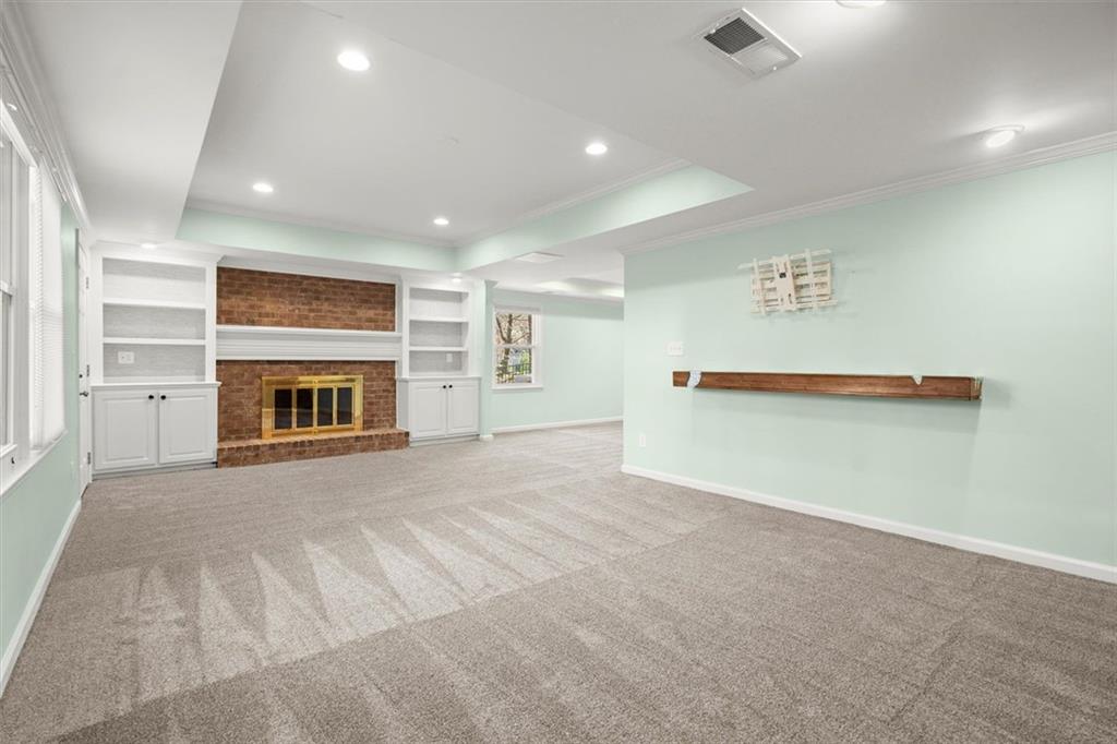 4367 Moss Ridge Court Northeast Roswell, GA 30075 - Photo 59 of 84 an empty room with fireplace and window