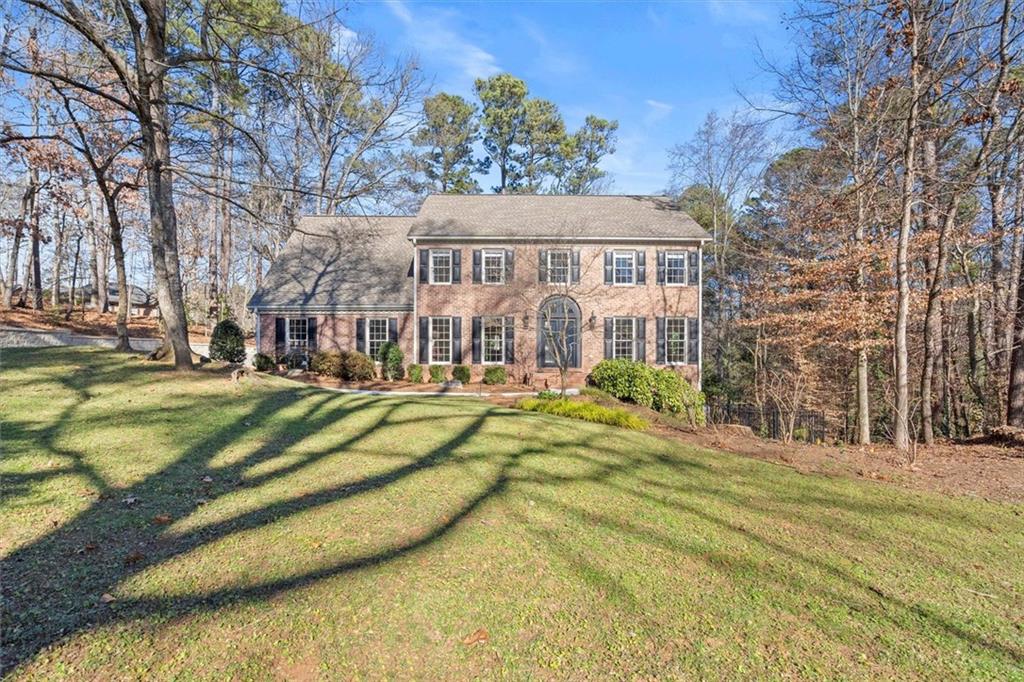 4367 Moss Ridge Court Northeast Roswell, GA 30075 - Photo 75 of 84 a view of a house with a large trees next to a yard