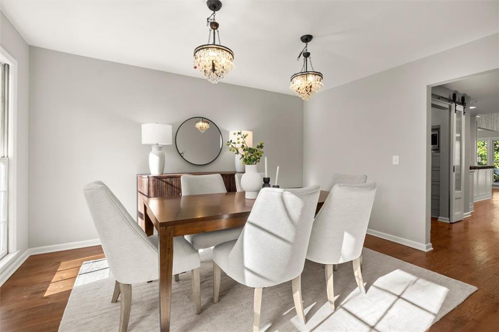 4367 Moss Ridge Court Northeast Roswell, GA 30075 - Photo 10 of 84 a view of a dining room with furniture wooden floor and a chandelier