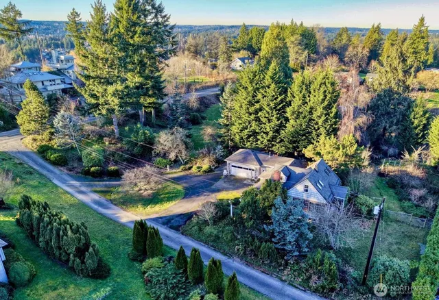 an aerial view of a house with a yard basket ball court and outdoor seating