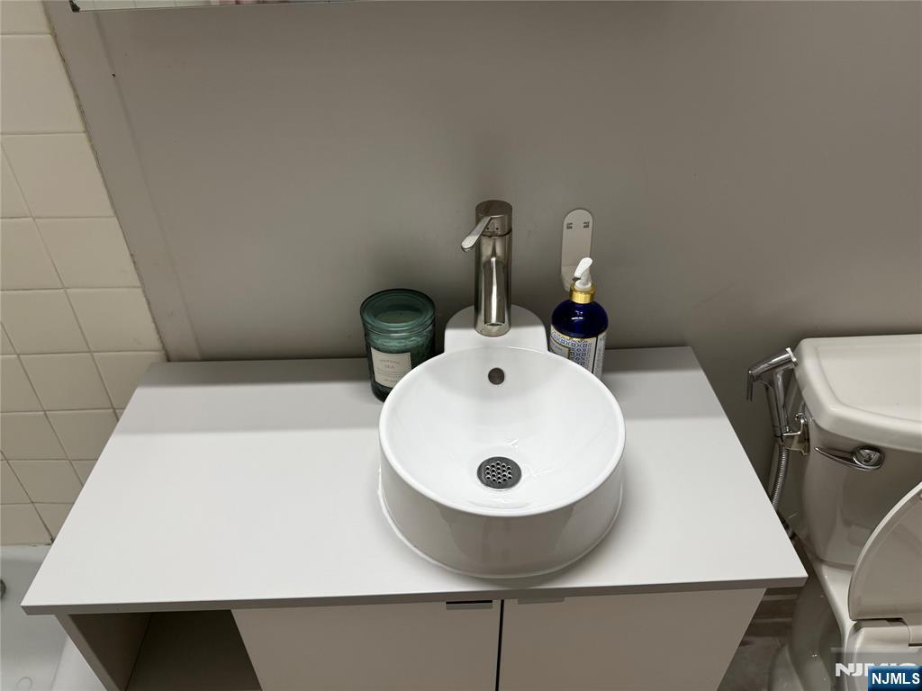 265 Main Street, Unit 702 Ridgefield Park, NJ 07660 - Photo 17 of 20 a bathroom with a sink and a mirror