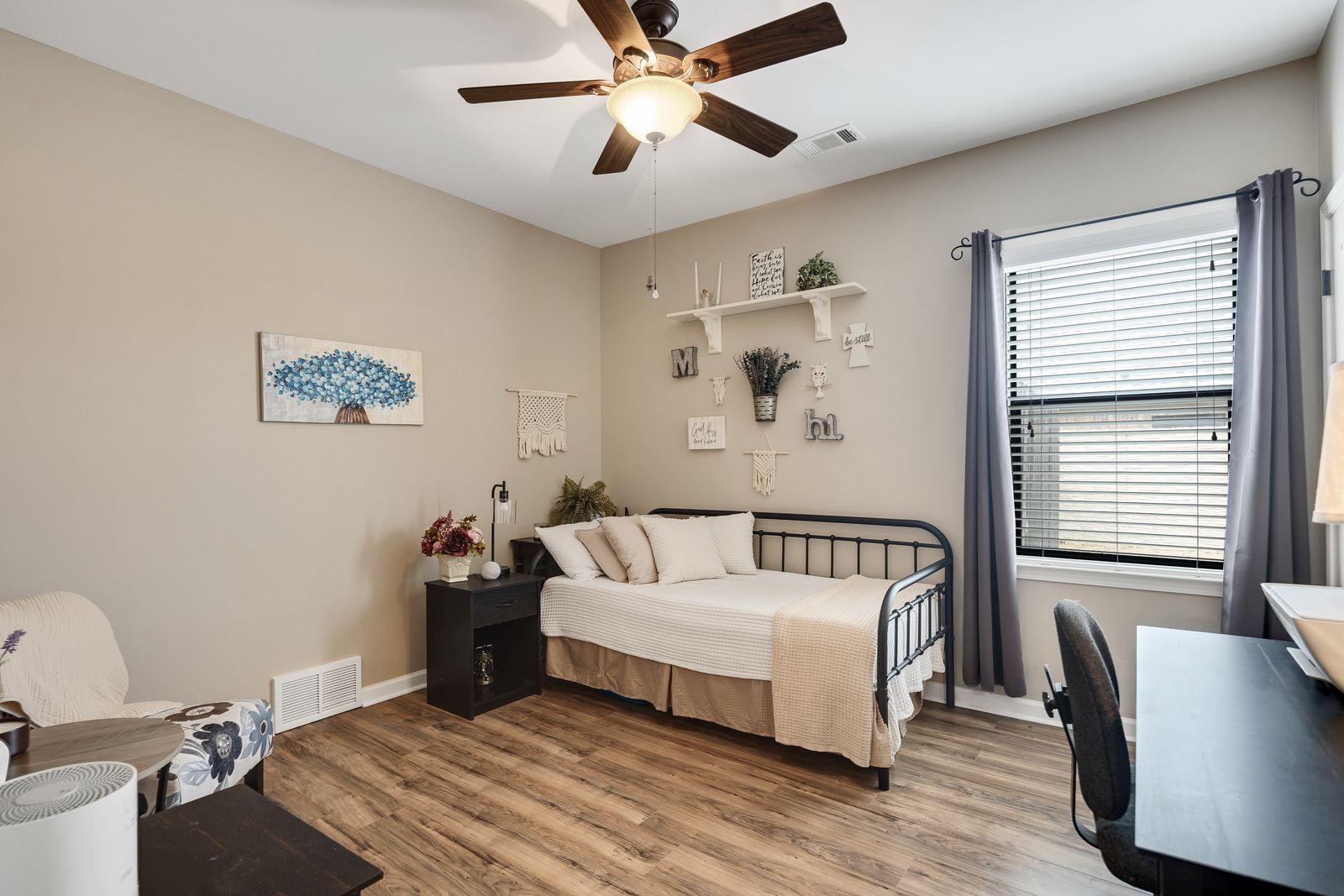 6247 Willow Walk Way Arlington, TN 38002 - Photo 23 of 40 a bedroom with a bed and a chandelier