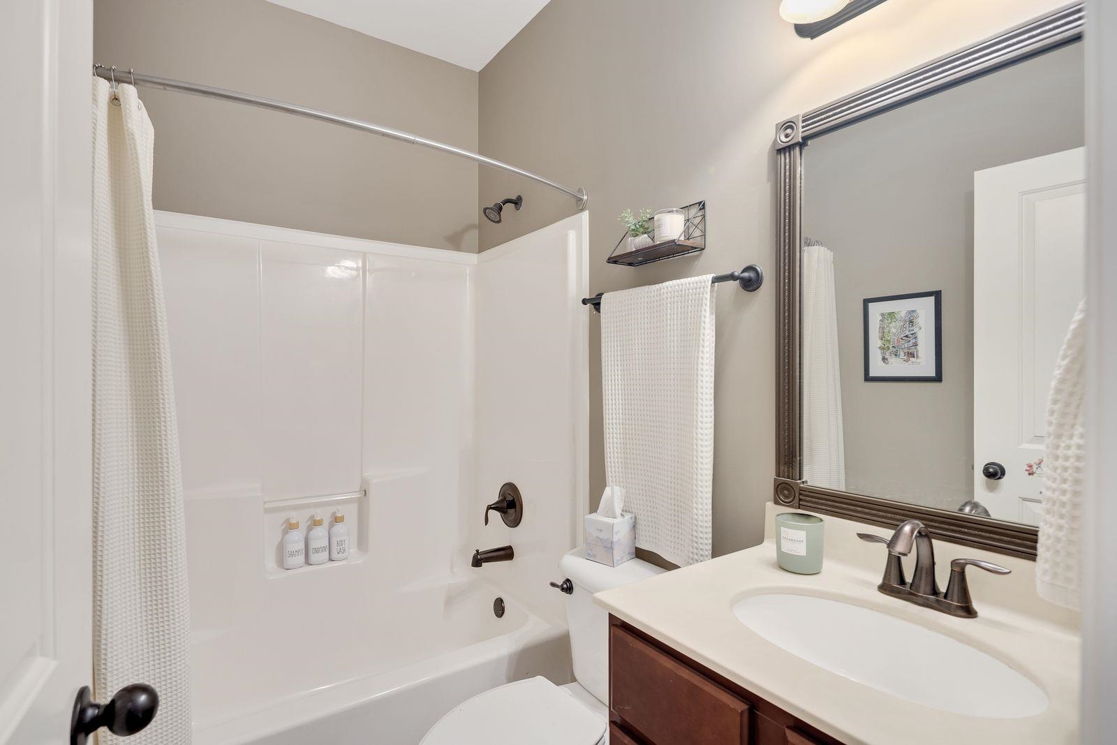 6247 Willow Walk Way Arlington, TN 38002 - Photo 24 of 40 a bathroom with a sink vanity granite tub shower and a mirror