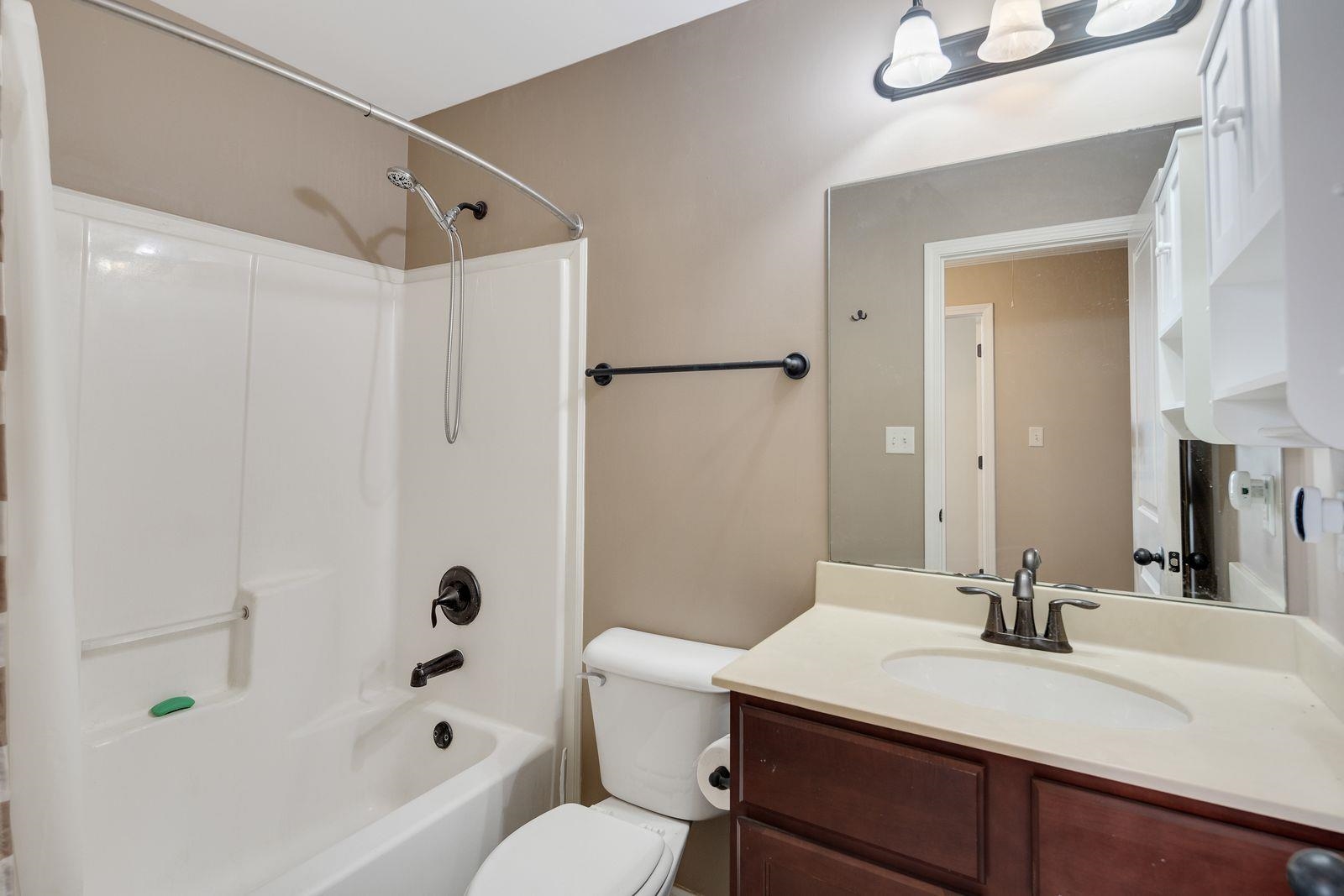 6247 Willow Walk Way Arlington, TN 38002 - Photo 27 of 40 a bathroom with a sink a toilet and shower
