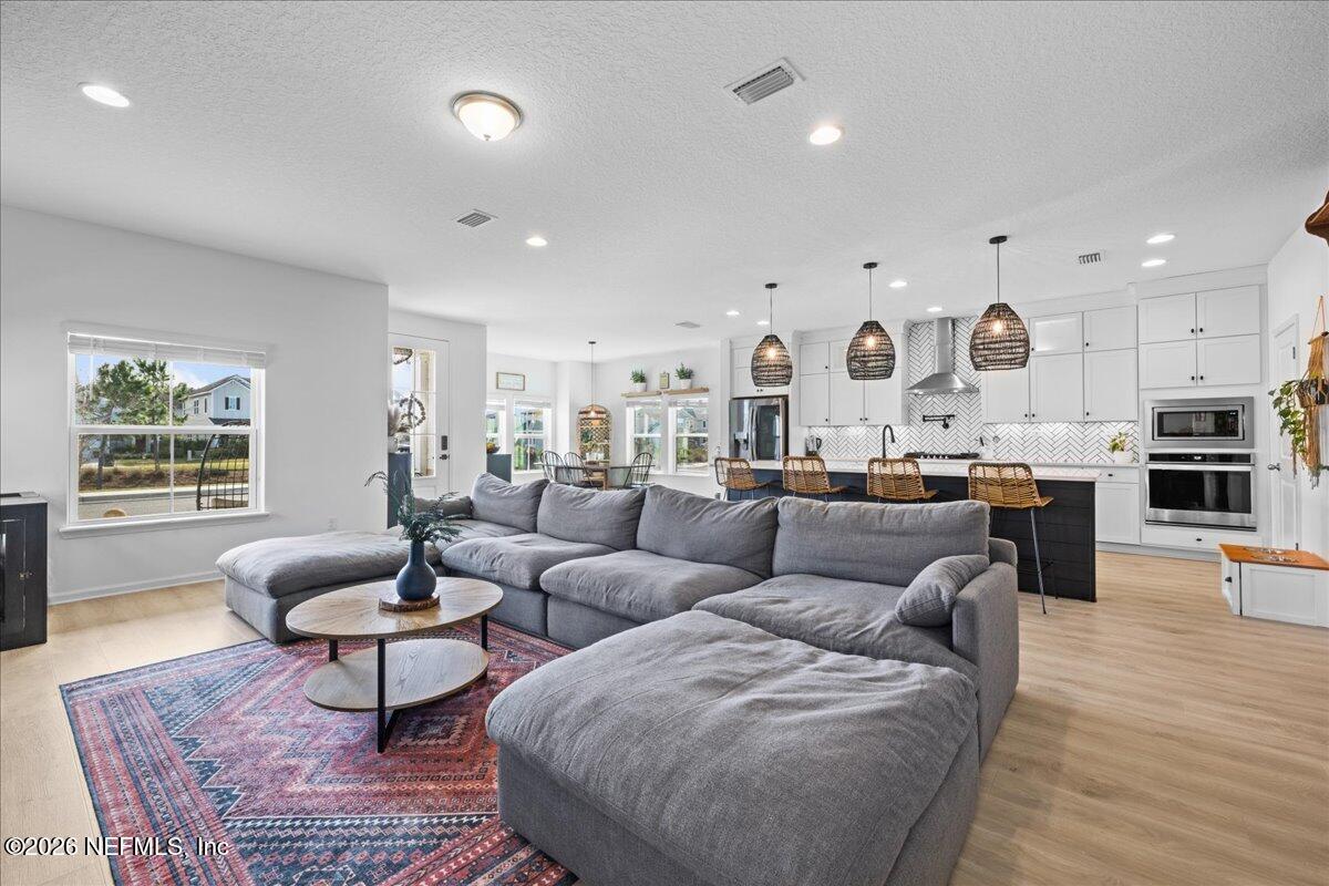 92 Patina Place St. Augustine, FL 32092 - Photo 10 of 26 a living room with furniture kitchen view and a large window