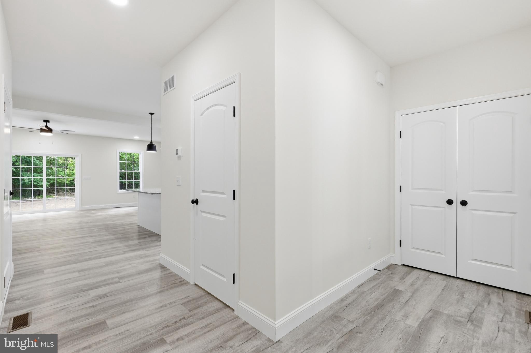 1354 College Road Dover, DE 19904 - Photo 9 of 46 a view of a hallway with wooden floor and a cabinet