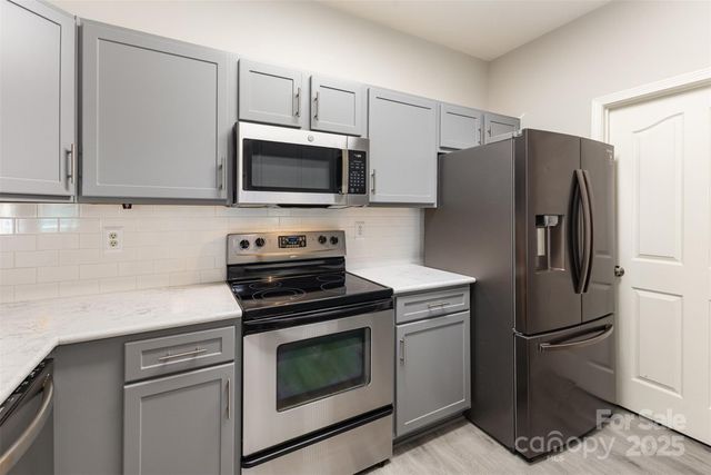 a kitchen with a refrigerator stove and microwave