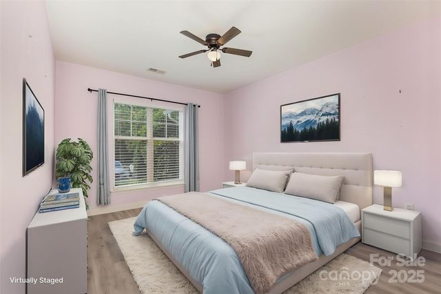 a bedroom with a large bed and a large window