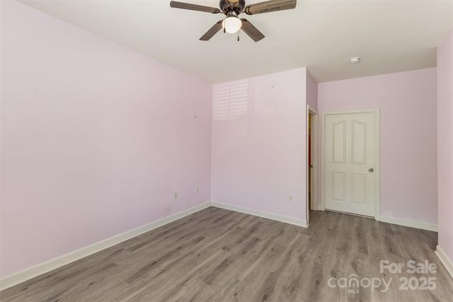 a view of a big room with wooden floor and fan