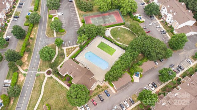 an aerial view of a house with a yard and potted plants