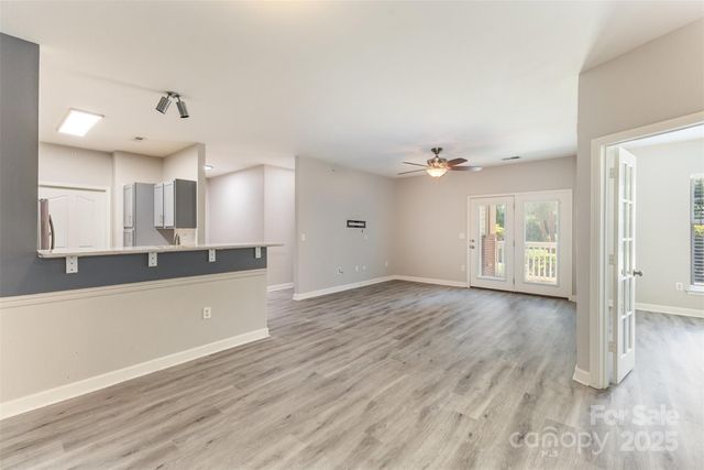 a view of a kitchen with wooden floor and a kitchen