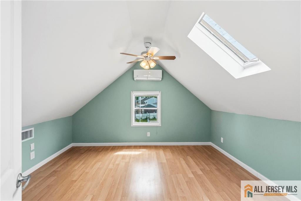 50 3rd Street Fords, NJ 08863 - Photo 23 of 36 a view of an empty room with window and wooden floor