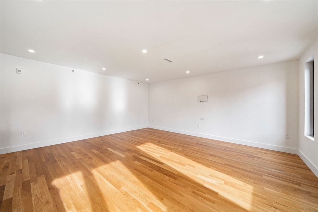 6 Devine Way, Unit 2 Boston, MA 02127 - Photo 20 of 39 a view of empty room with wooden floor