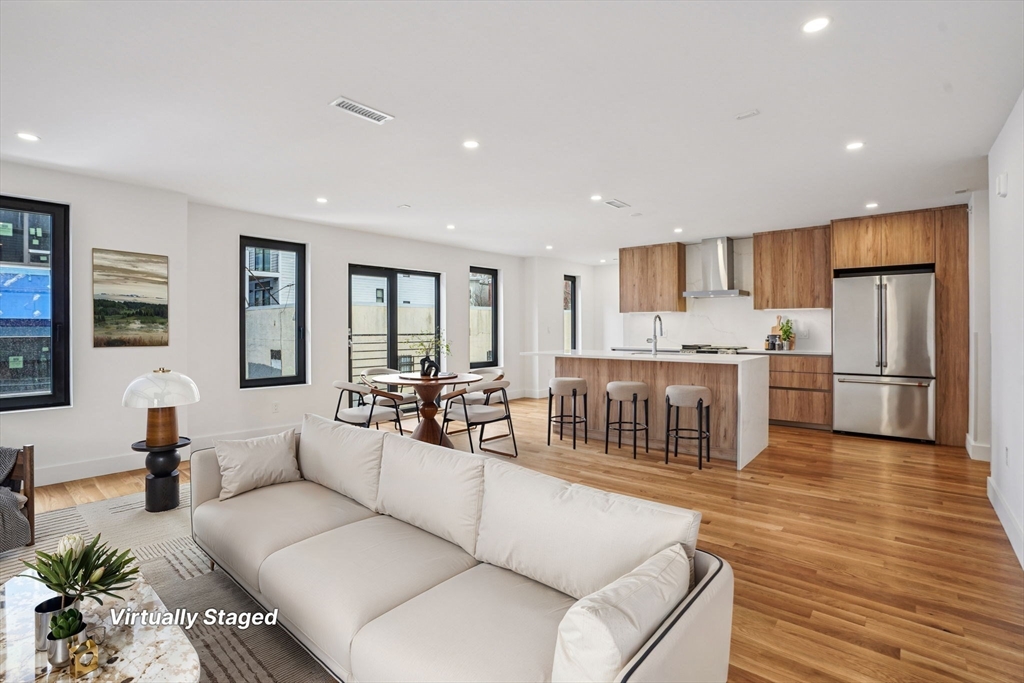 6 Devine Way, Unit 2 Boston, MA 02127 - Photo 2 of 39 a living room with stainless steel appliances furniture cabinets and a wooden floor
