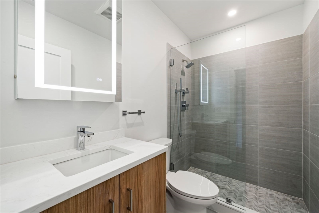 6 Devine Way, Unit 2 Boston, MA 02127 - Photo 24 of 39 a bathroom with a sink a toilet and shower