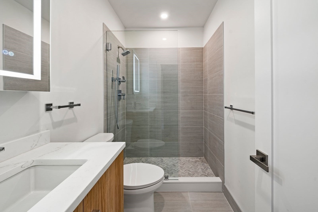6 Devine Way, Unit 2 Boston, MA 02127 - Photo 25 of 39 a bathroom with a sink a toilet and shower