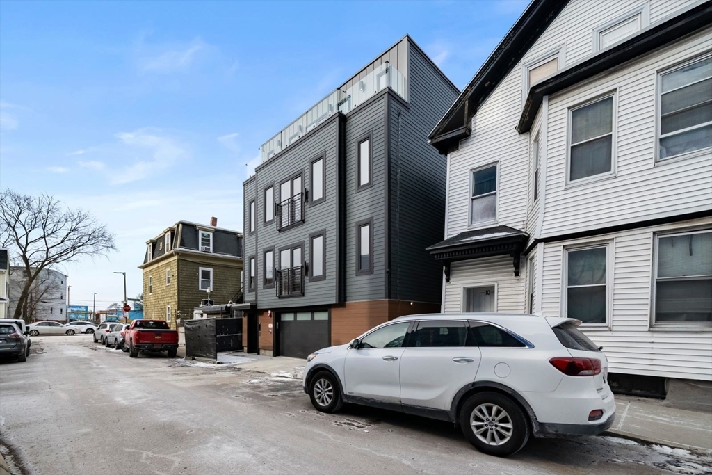 6 Devine Way, Unit 2 Boston, MA 02127 - Photo 32 of 39 a car parked in front of a white house