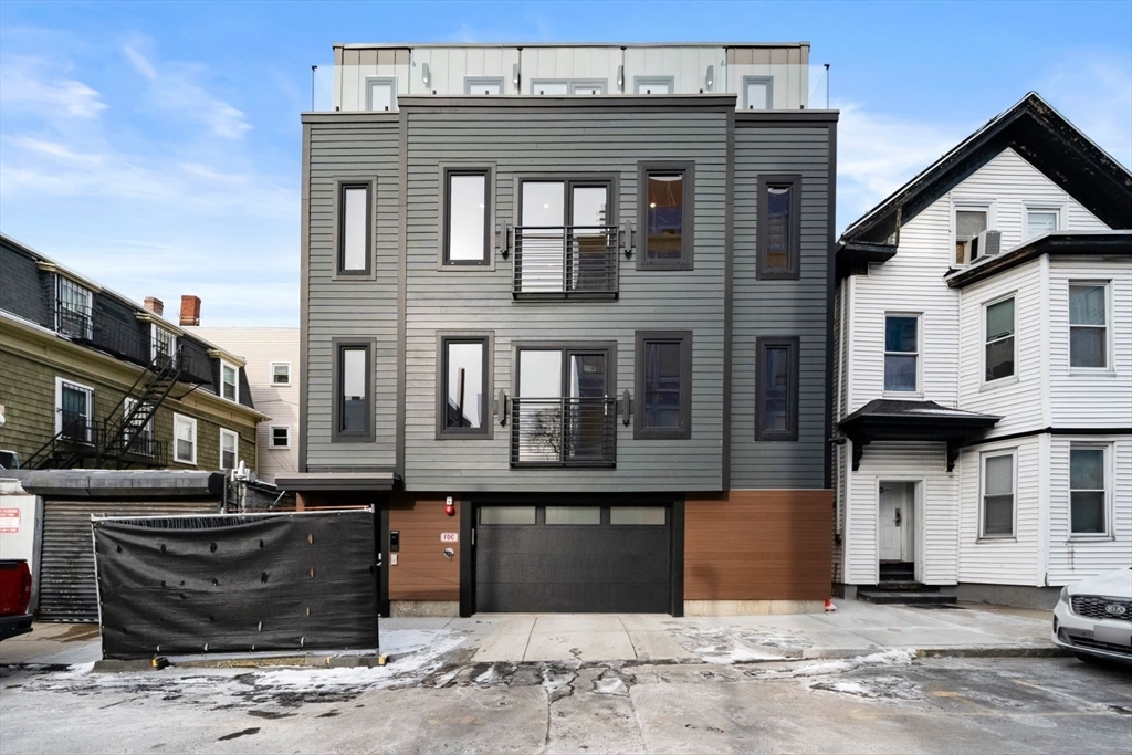 6 Devine Way, Unit 2 Boston, MA 02127 - Photo 33 of 39 a front view of a building with a road