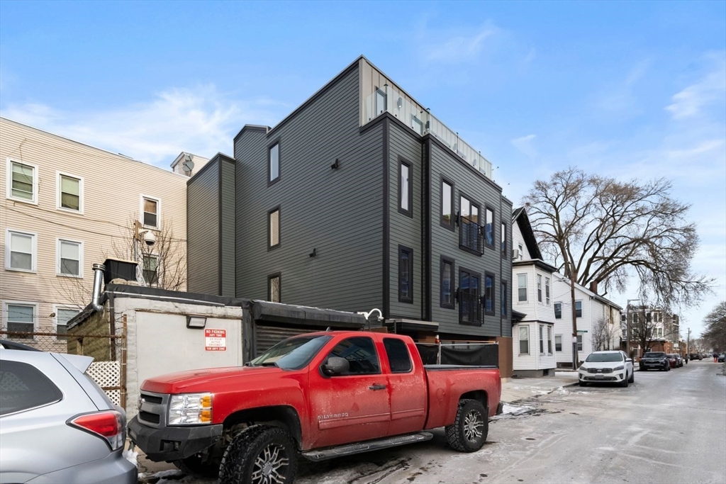 6 Devine Way, Unit 2 Boston, MA 02127 - Photo 34 of 39 a view of a cars park in front of a building