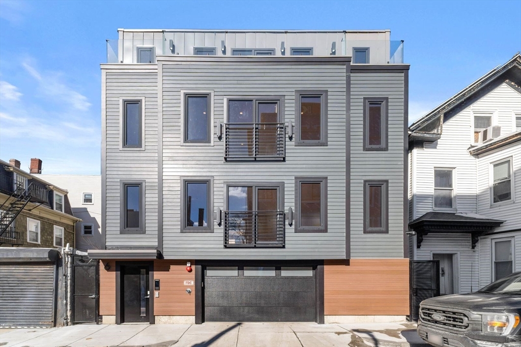 6 Devine Way, Unit 2 Boston, MA 02127 - Photo 35 of 39 a front view of a building with many windows