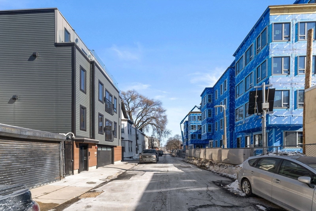 6 Devine Way, Unit 2 Boston, MA 02127 - Photo 37 of 39 a city street lined with buildings and cars