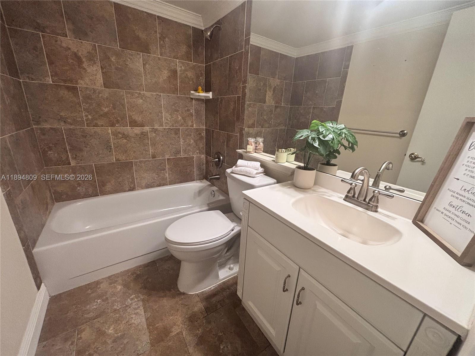 8050 West McNab Road, Unit 212 Tamarac, FL 33321 - Photo 11 of 19 a bathroom with a sink a toilet and bathtub