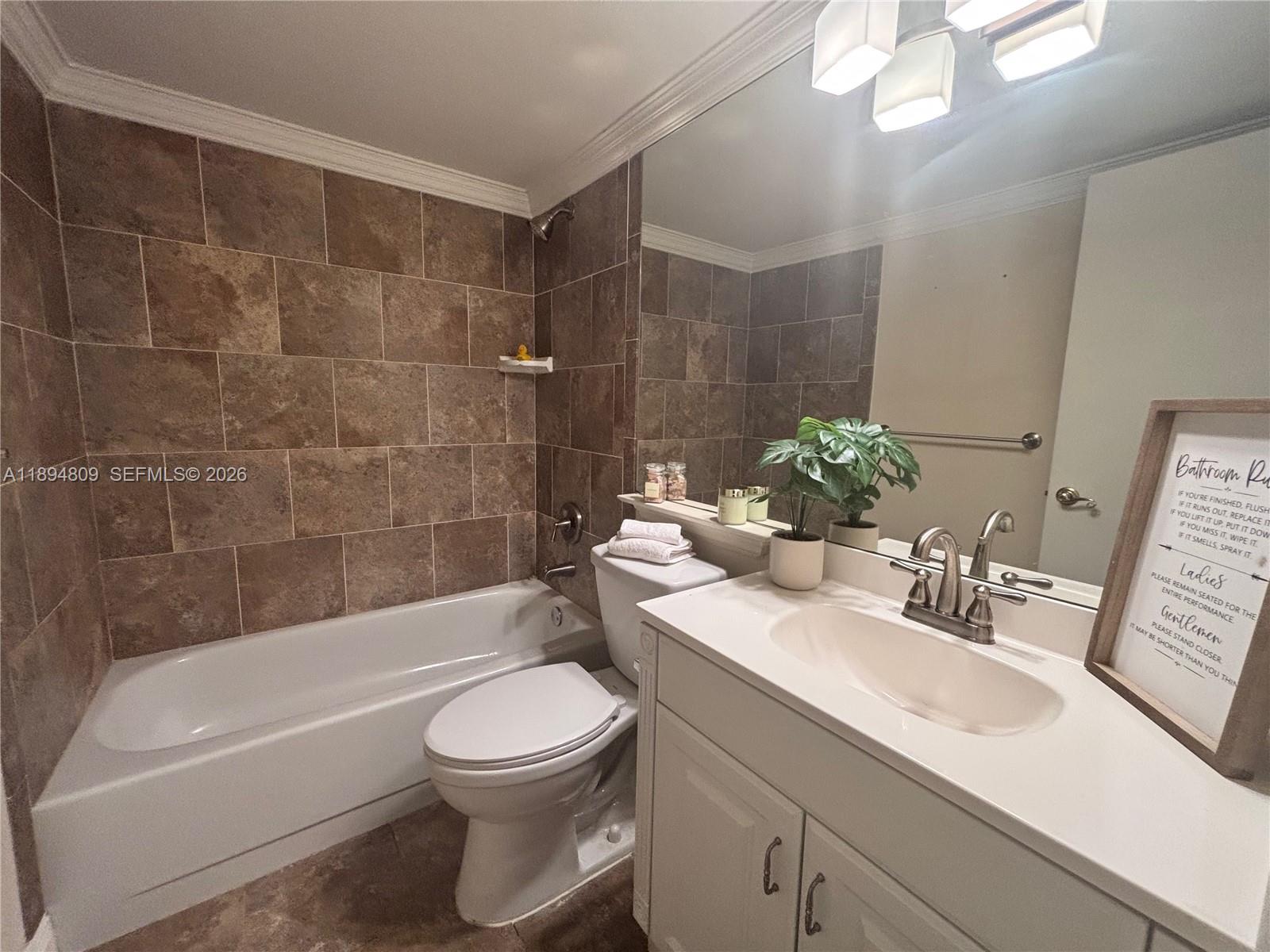 8050 West McNab Road, Unit 212 Tamarac, FL 33321 - Photo 12 of 19 a bathroom with a sink a toilet and bathtub