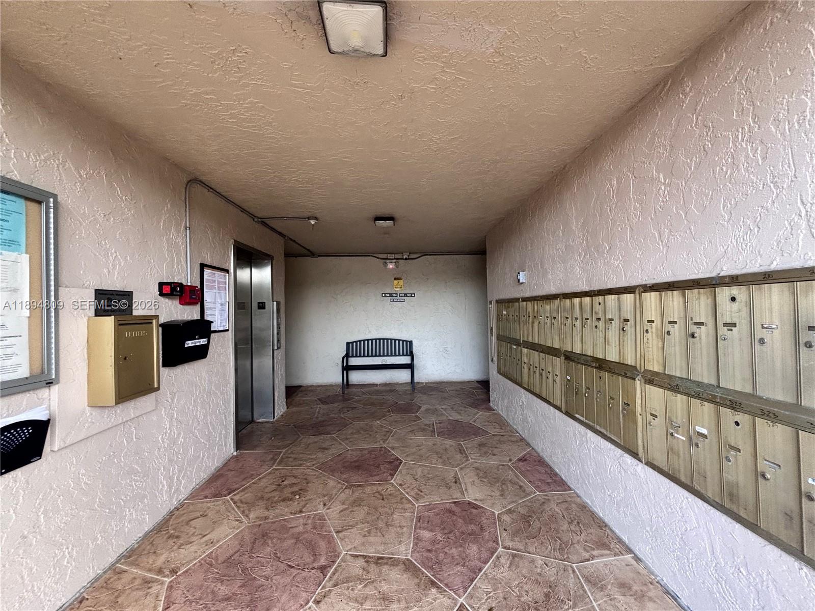 8050 West McNab Road, Unit 212 Tamarac, FL 33321 - Photo 14 of 19 a view of a hallway with seating area