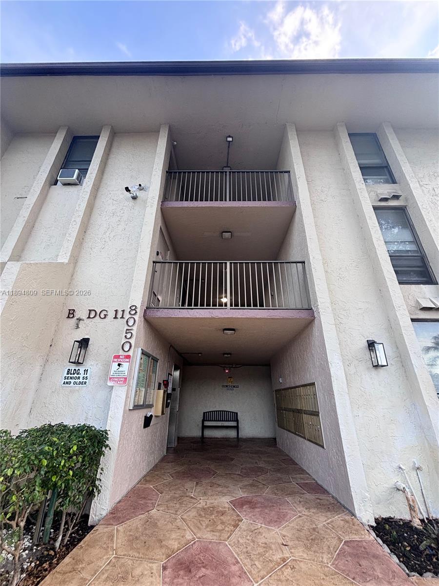 8050 West McNab Road, Unit 212 Tamarac, FL 33321 - Photo 15 of 19 a view of a hallway with a staircase