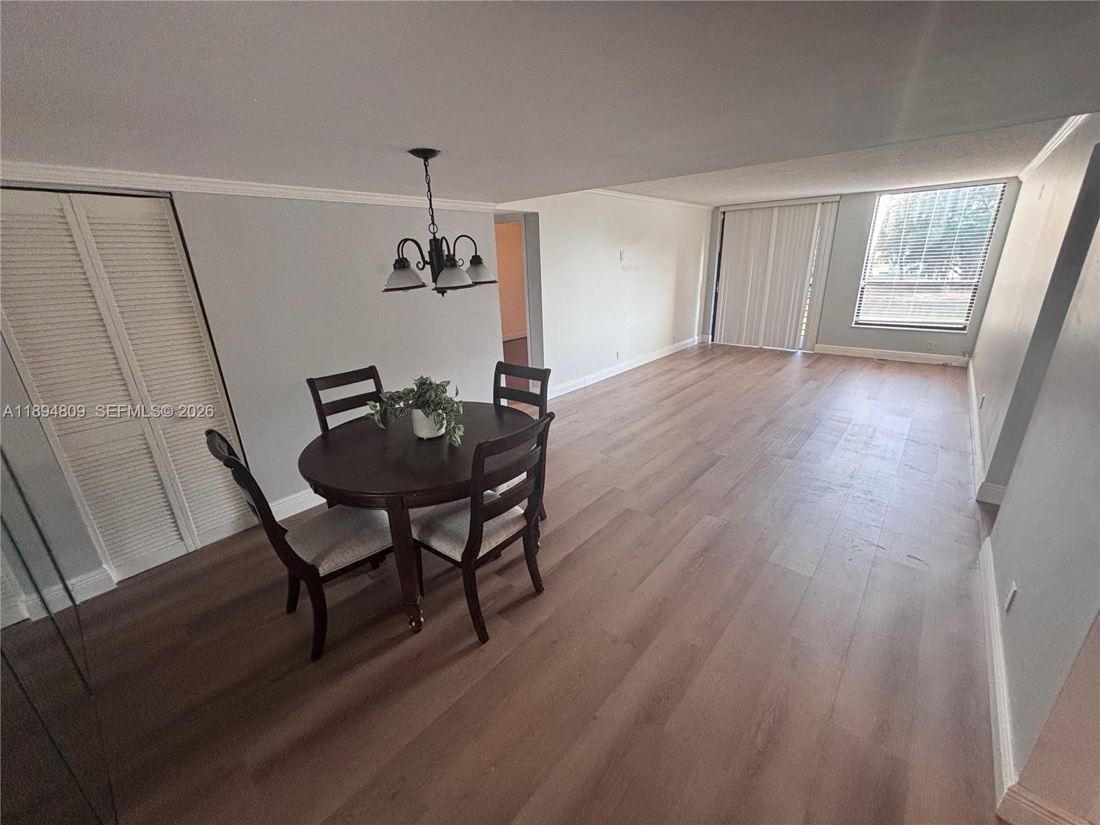 8050 West McNab Road, Unit 212 Tamarac, FL 33321 - Photo 2 of 19 a view of a room with furniture window and wooden floor
