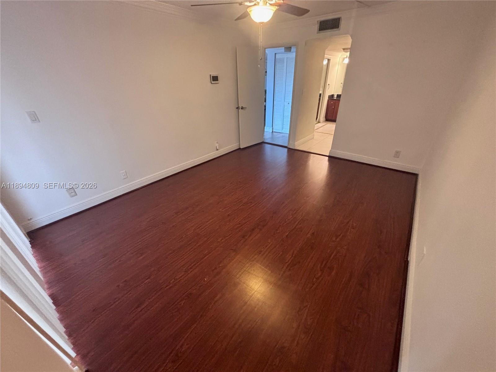 8050 West McNab Road, Unit 212 Tamarac, FL 33321 - Photo 6 of 19 a view of an empty room with wooden floor