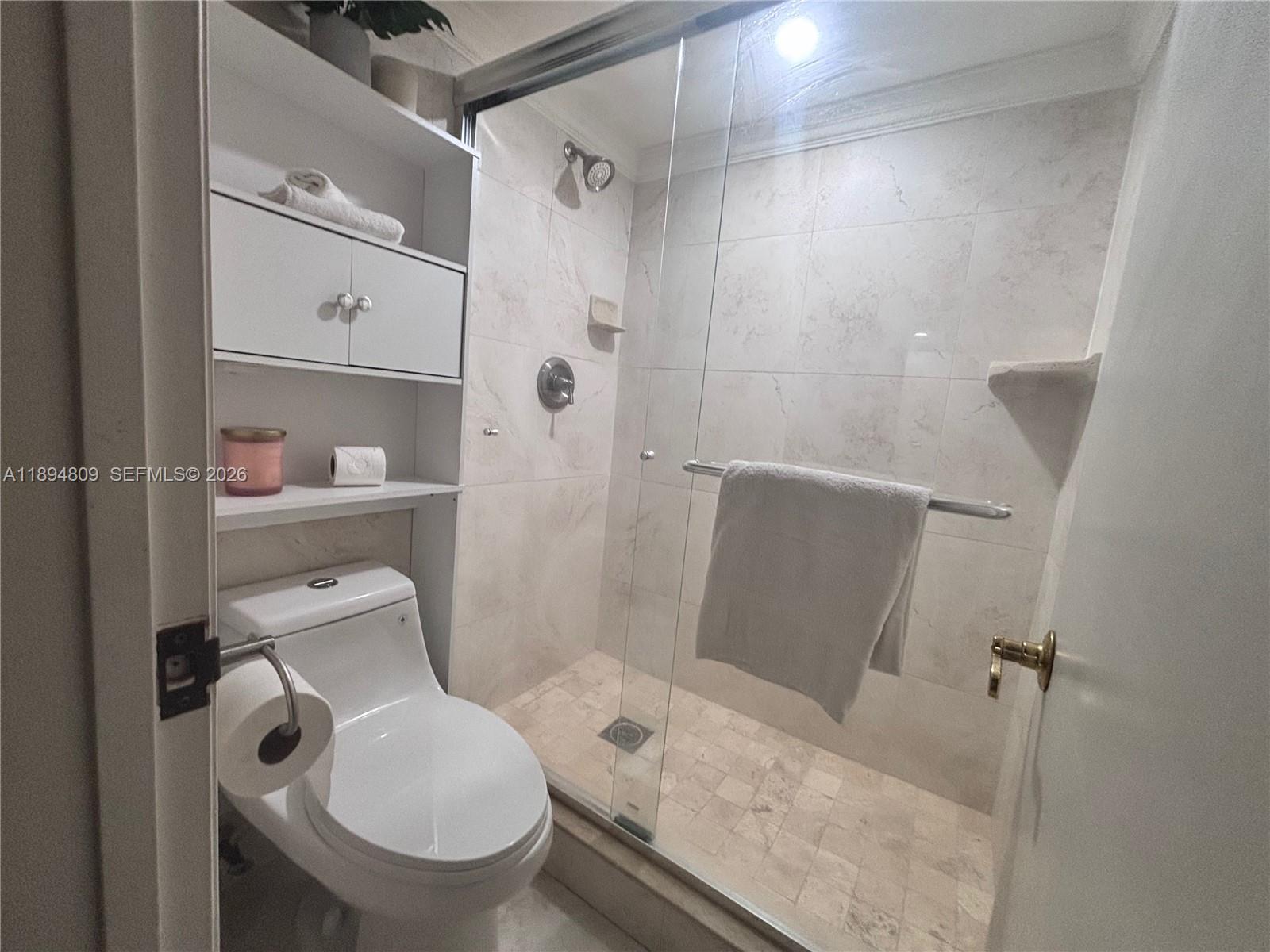 8050 West McNab Road, Unit 212 Tamarac, FL 33321 - Photo 7 of 19 a bathroom with a toilet and a shower