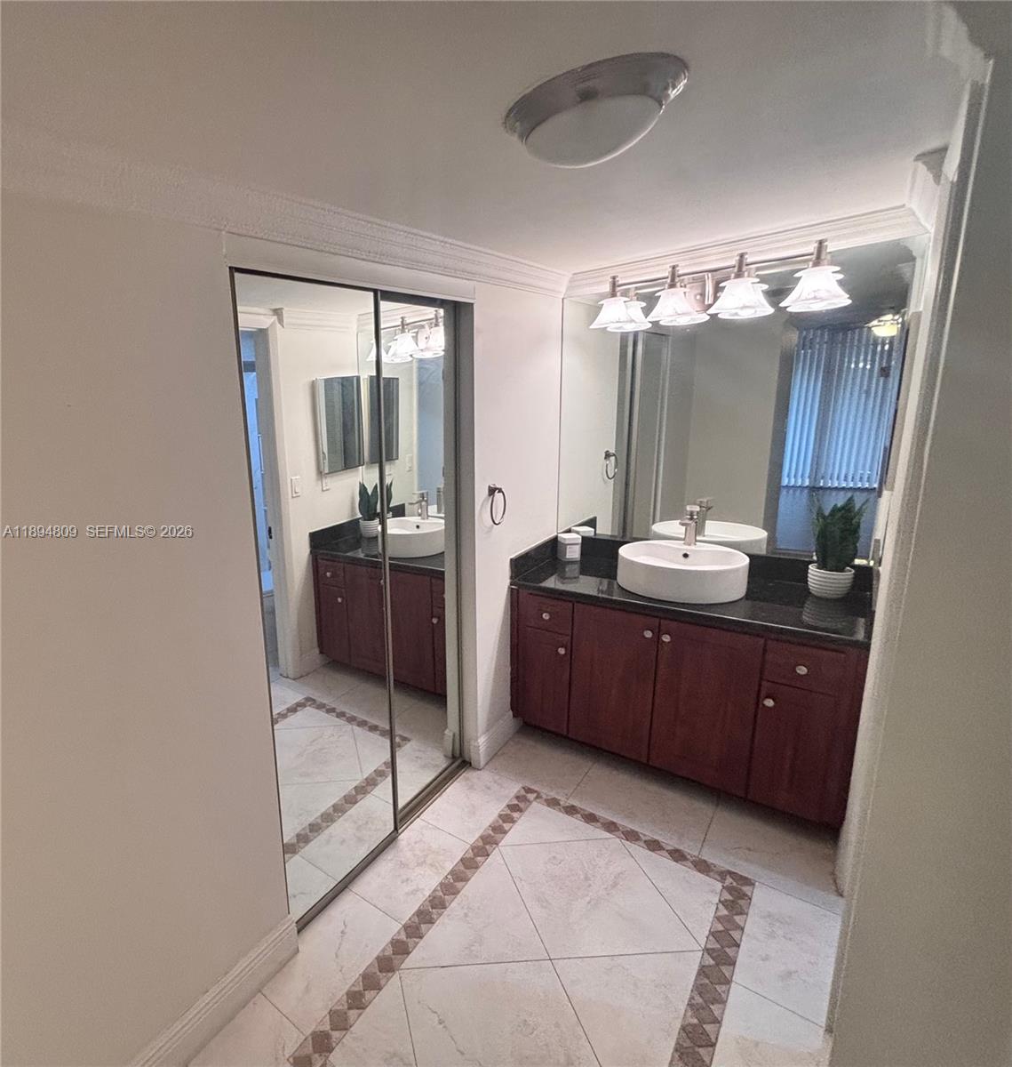 8050 West McNab Road, Unit 212 Tamarac, FL 33321 - Photo 9 of 19 a spacious bathroom with a granite countertop sink a mirror and shower