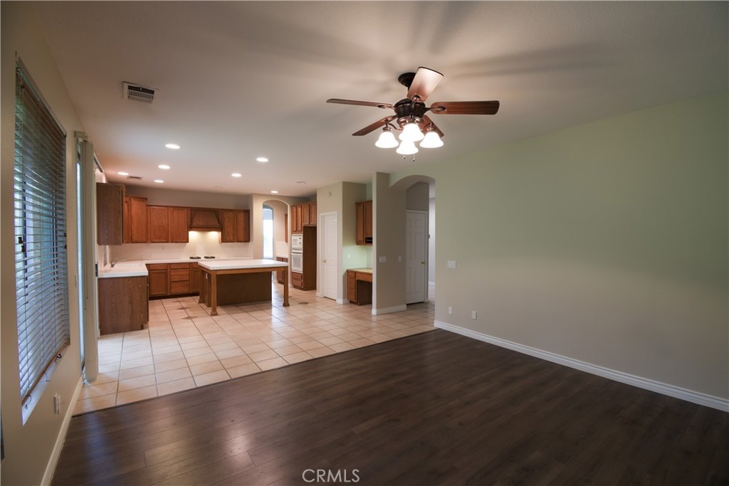 39705 Primrose Circle Murrieta, CA 92563 - Photo 11 of 31 a view of a livingroom with furniture a ceiling fan and wooden floor