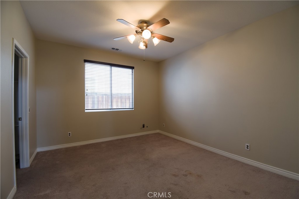 39705 Primrose Circle Murrieta, CA 92563 - Photo 14 of 31 an empty room with a window and a ceiling fan