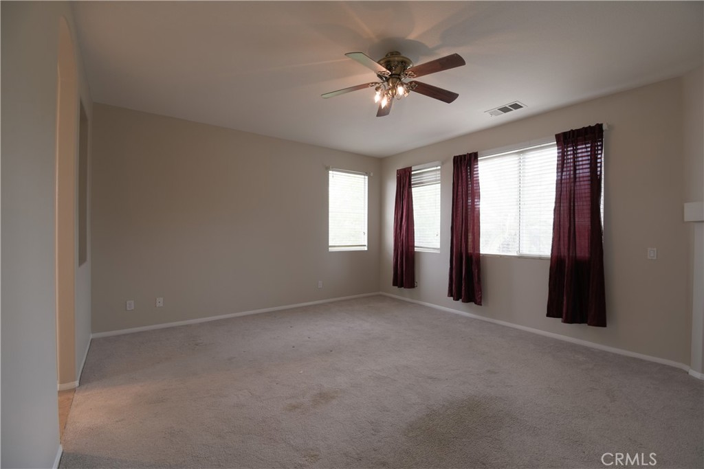 39705 Primrose Circle Murrieta, CA 92563 - Photo 19 of 31 a view of an empty room with windows and chandelier fan