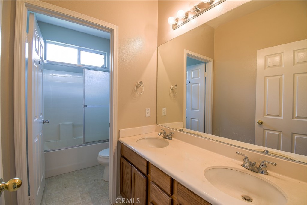 39705 Primrose Circle Murrieta, CA 92563 - Photo 27 of 31 a bathroom with a sink a toilet and shower