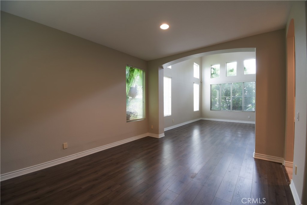 39705 Primrose Circle Murrieta, CA 92563 - Photo 5 of 31 an empty room with wooden floor and windows