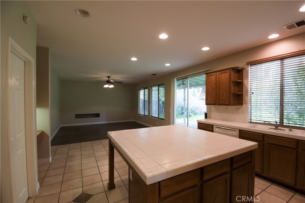 39705 Primrose Circle Murrieta, CA 92563 - Photo 9 of 31 a kitchen with a stove a sink a microwave and a refrigerator