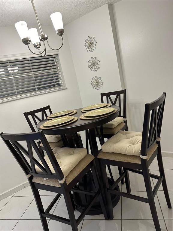 1881 Washington Avenue Miami Beach, FL 33139 - Photo 7 of 13 a view of a dining room with furniture and wooden floor